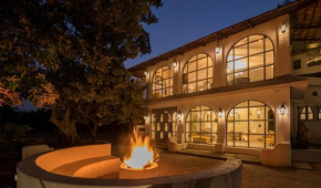 StayVista's Casa Blanca - Modern elegance with a pool, spacious lawn & diverse activities